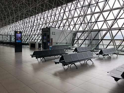 space black metal gang chairs on white ceramic flooring seatting