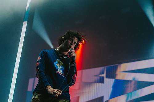 human man singing on stage person