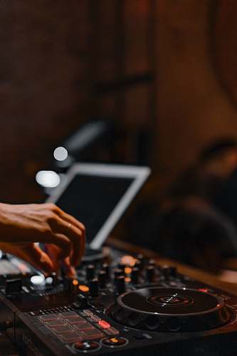 human person using black and gray audio mixer person