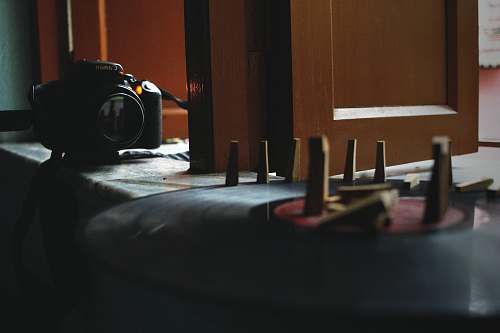 camera black DSLR camera on white and blue textile table