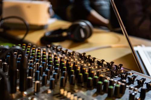 computer person near headphones and mixer keyboard