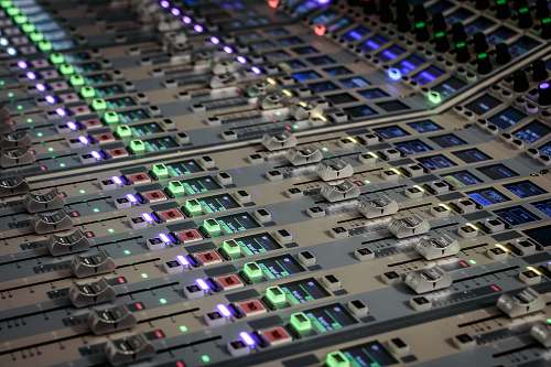 console turned-on white and multicolored audio equalizer fader