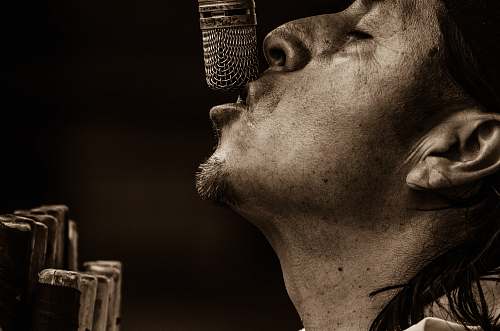 sing man singing with microphone grayscale photography singer
