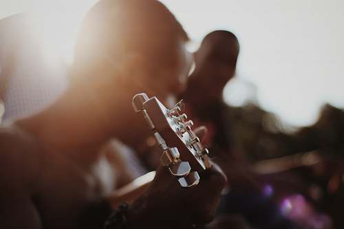 france man playing guitar brown