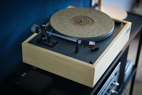 audio beige turntable on black wooden table recordplayer