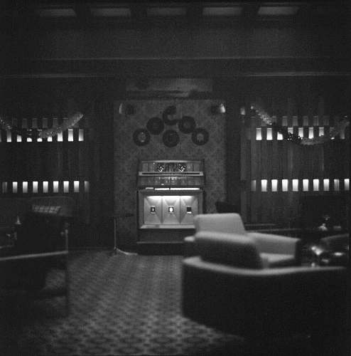 black-and-white grayscale photo of chairs and fireplace aed studios nv