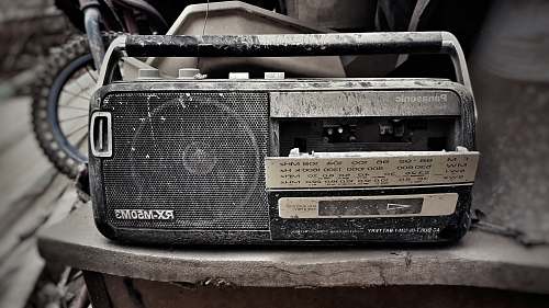 radio grey and black Panasonic RX-M50M3 transistor radio on grey surface broken