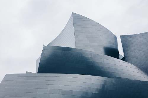 crowd photo of building top under gray sky audience