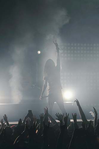 anaheim woman standing on stage holding microphone concert