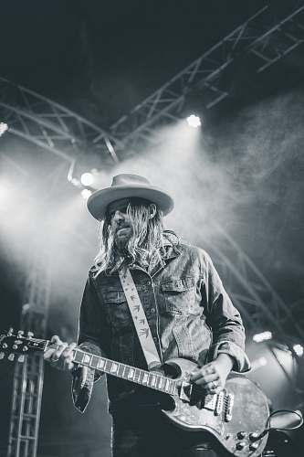 grey man playing guitar guitarist