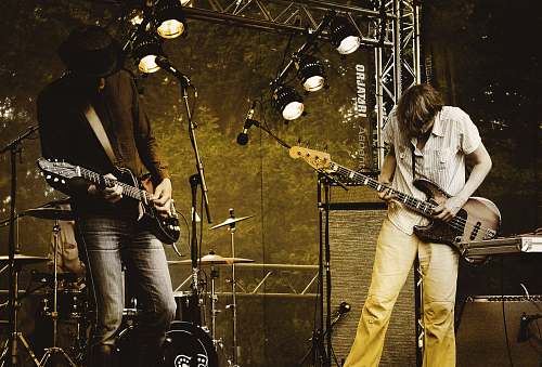 human two men performing guitar on stage people