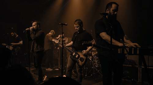 person band group performing on stage guitar