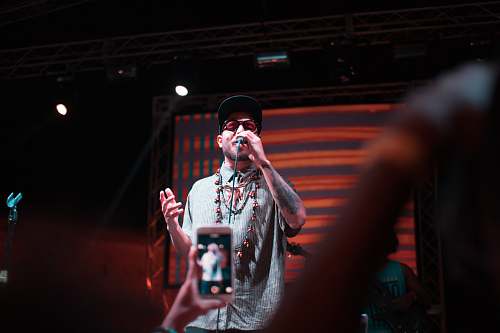 person band vocalist performing on stage people