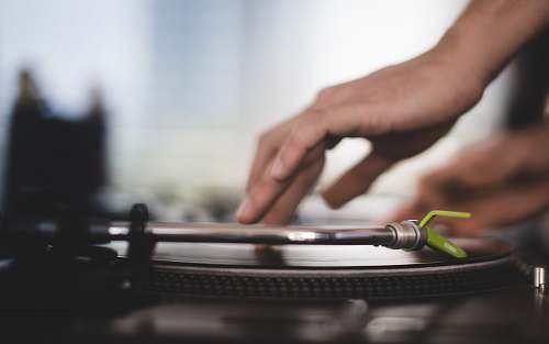person close-up photo of person using turntable hand