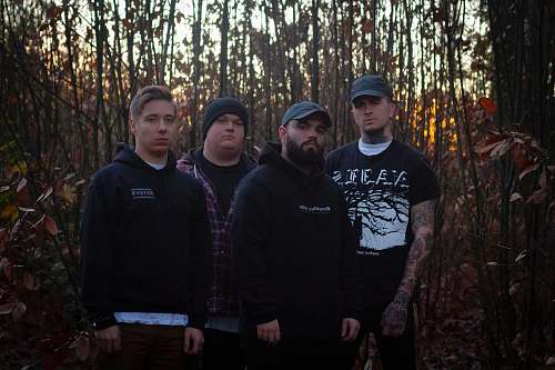 apparel four men standing on front of woods clothing
