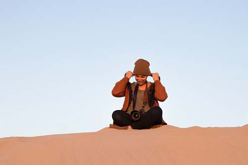 person girl sitting on dessert ground people