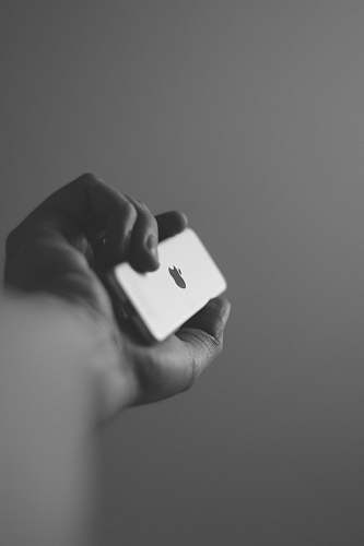 black-and-white grayscale photography of person holding iPod grey