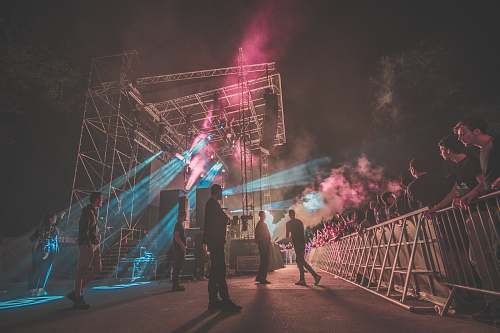 person group of men concerting on stage surrounded by people people