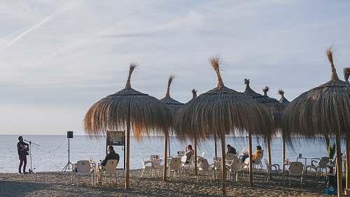 person group of people standing on beach during daytime chair
