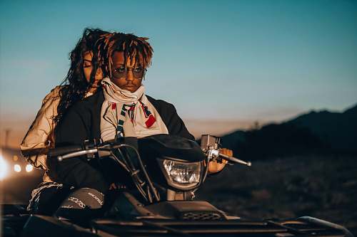 person man and woman riding on ATV clothing