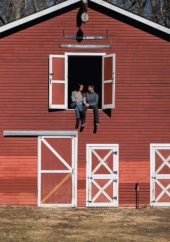 person man and woman sitting in stable window people