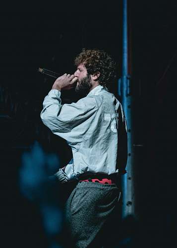 person man holding cordless microphone on stage people