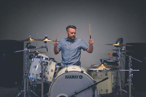 person man holding drum sticks with sitting on throne drummer