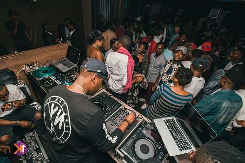 people man in black and white shirt and people dancing inside well lit room person