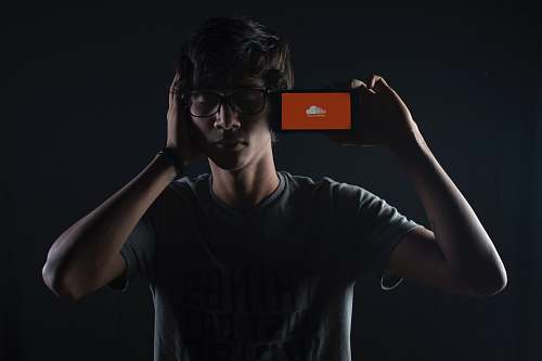 person man listening to Soundcloud music on smartphone people