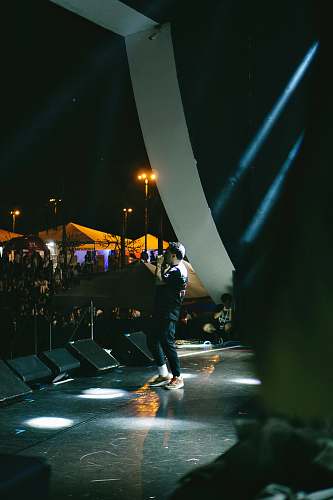 person man performing on concert stage lighting