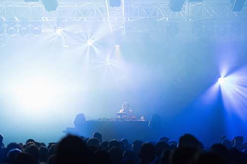 person man performing on stage front of crowd crowd