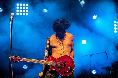 person man play electric guitar people