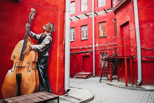 person man playing cello mural girl