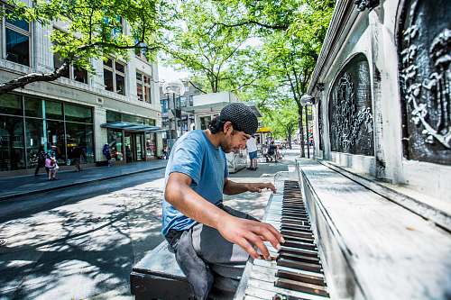 person man playing piano on street people