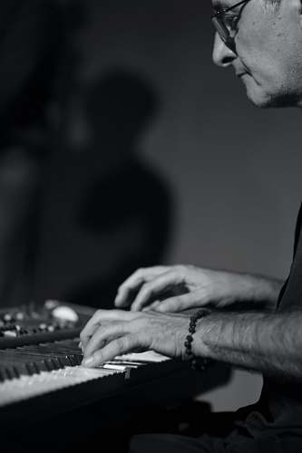 person man playing piano black-and-white