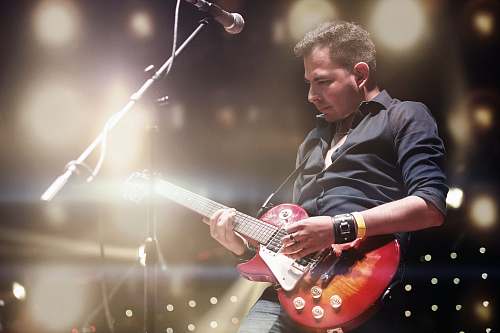 person man playing the electric guitar people