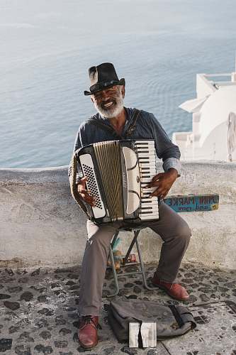 person man playing white accordion musician