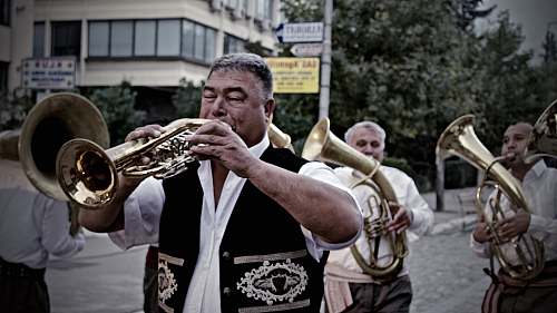 person man playing wind instrument brass section