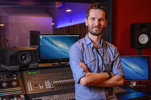 person man standing behind audio mixer in studio people
