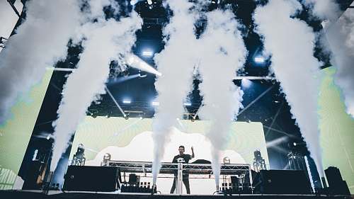 person man standing in front of stage to perform building