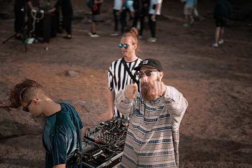 person man standing near black audio mixer people