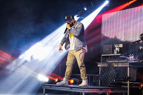 person man standing on stage during nighttime people