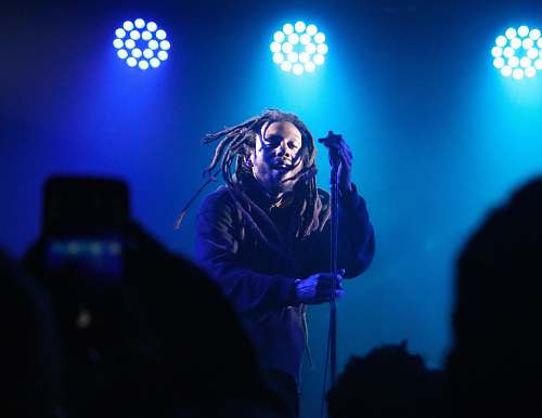 people man standing on stage with blue spotlight person