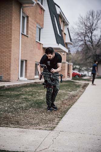 person man using drone standing in green field clothing