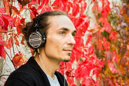person man wearing black and gray headphones headphones