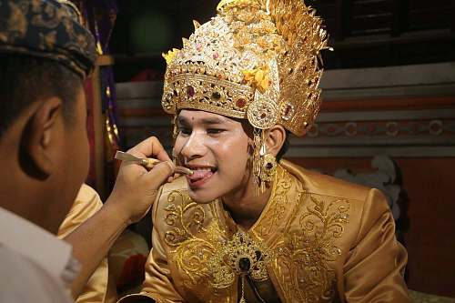 person man wearing gold head dress opening his mouth people
