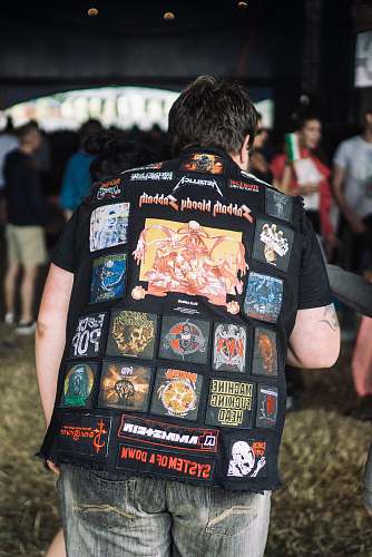 clothing man wearing vest near building apparel