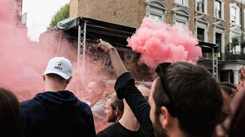 person people near pink smoke apparel