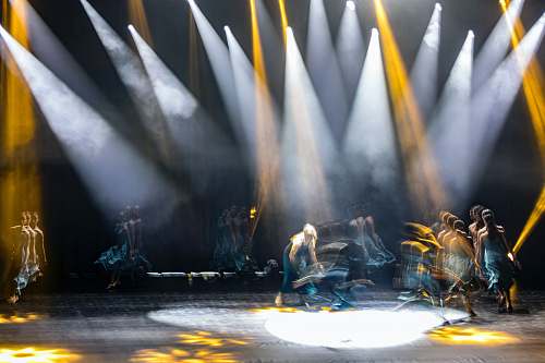person people performing on stage lighting