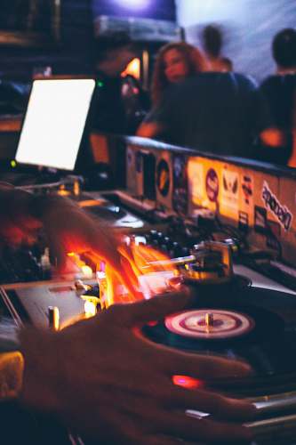 person person holding black and grey DJ turntable dj
